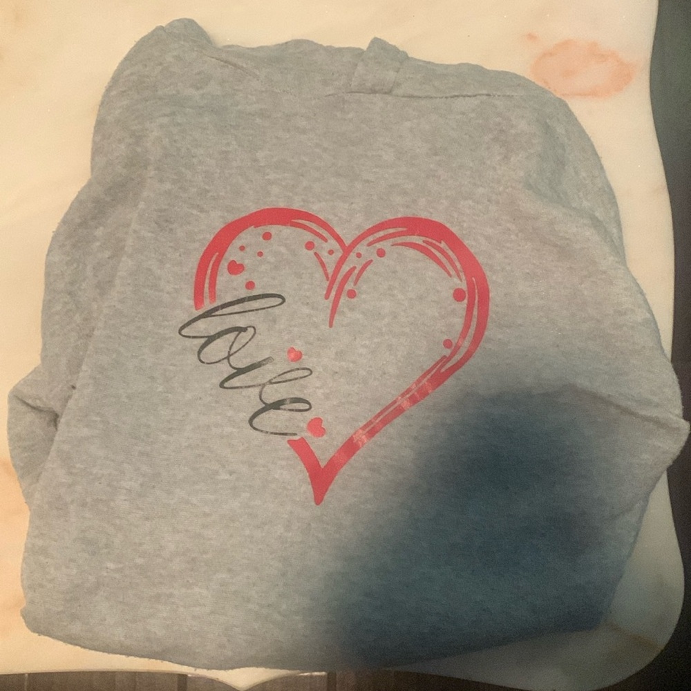 I am selling a cute light grey heart designed hoodie
